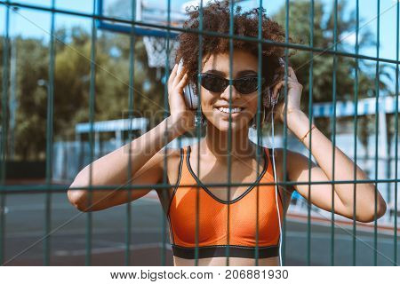 African-american Woman Listening To Music In Headphones