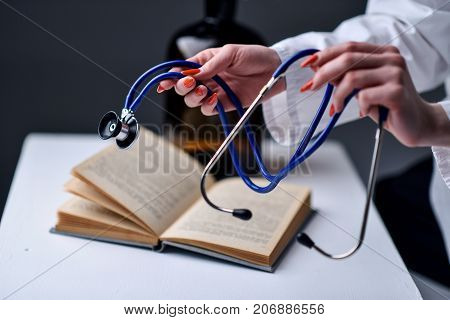A stethoscope in the hands of the doctor
