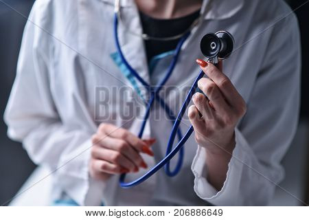 A stethoscope in the hands of the doctor