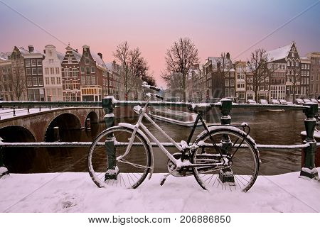Sunset in snowy Amsterdam in the Netherlands in winter