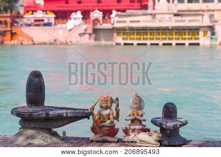 Hindu Religion Symbols On The Bank Of The Ganges River, Sacred Waters. Shiva Sculpture And Lingam. D