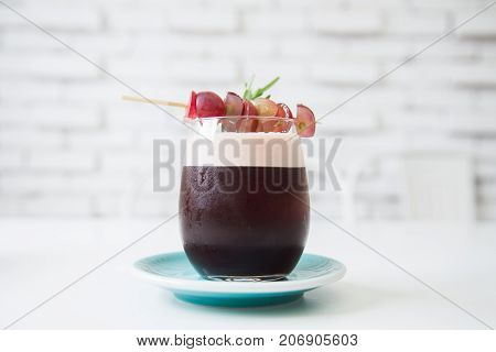 Grape mint soda mocktail with fresh grapes.Soft focus of fresh mocktail drink in vintage coffee shop.Traditional summer drink