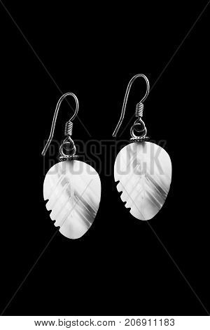 Elegant vintage white pearl earrings on black background