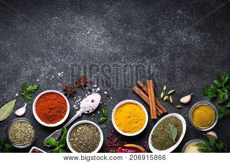 Set of Various spices and herbs on black slate table. Top view with copy space. Foood background.