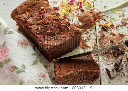 Decorated Homemade Chocolate Cake on white wooden background