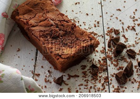 Homemade Chocolate Cake with grated Chocolate on white wooden table