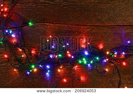 Christmas rustic background - vintage planked wood with lights and free text space.