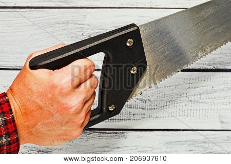 Hand Holding A Hand Saw