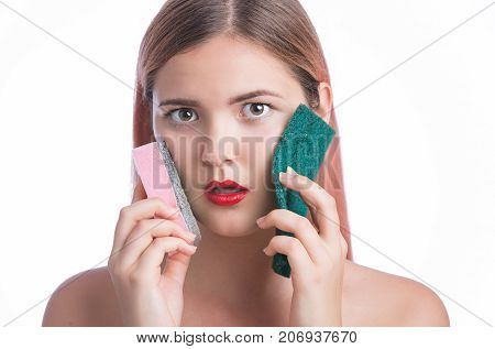 Portrait Of A Young Girl Holding Sponges To Clean Her Face