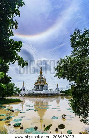 Magnificent Wat Thung Setthi (The Great Jewel Chedi of the three worlds) with amazing sun halo and reflection Khon Kaen thailand
