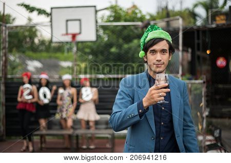 Young People Holding Glass Talk In The Party.