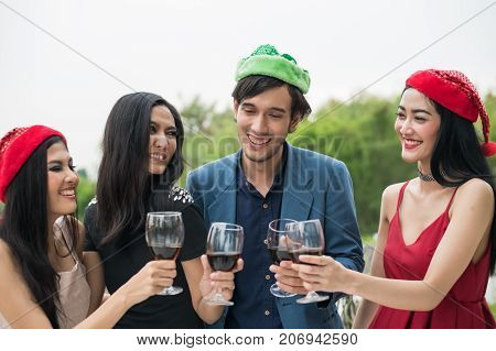 Young People Holding Glass Talk In The Party.