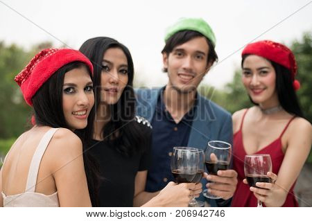 Young People Holding Glass Talk In The Party.
