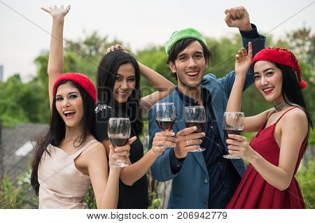 Young People Holding Glass Talk In The Party.