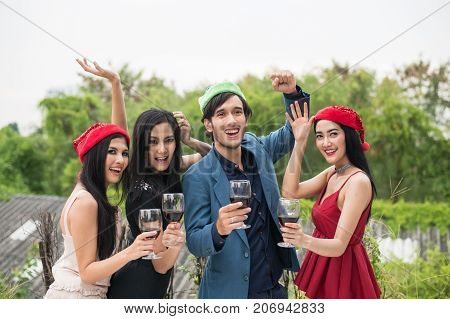 Young People Holding Glass Talk In The Party.