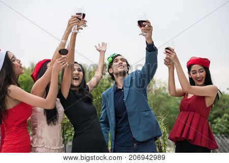 Young People Holding Glass Talk In The Party.