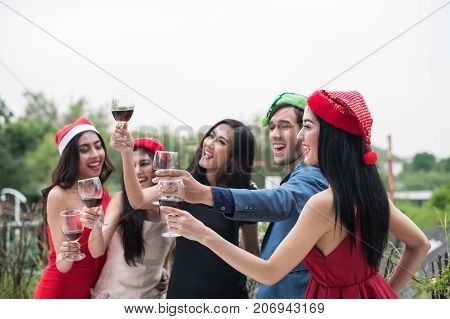 Young People Holding Glass Talk In The Party.