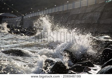 splashes of sea waves on the coast with large stones. storm. background