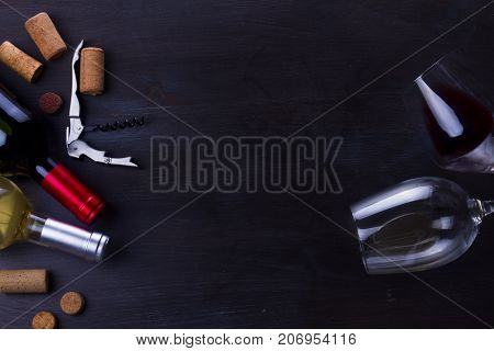 Bottle of red wine and two wine glasses on table with copy space