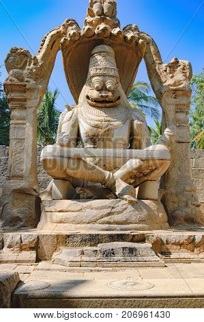 The Lakshmi Narasimha statue is the largest monolith statue in Hampi, Karnataka, India. The god is sitting in a cross-legged Yoga position on the coil of a giant seven-headed snake called Sesha.
