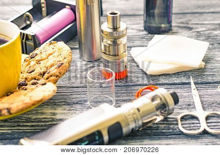 Still Life With Electronic Cigarette With Botle And Coffe On The Wooden Background