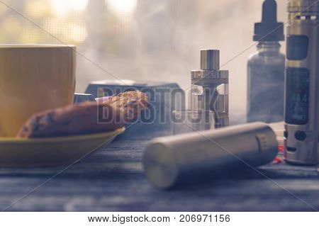 Still Life With Electronic Cigarette With Botle And Coffe On The Wooden Background