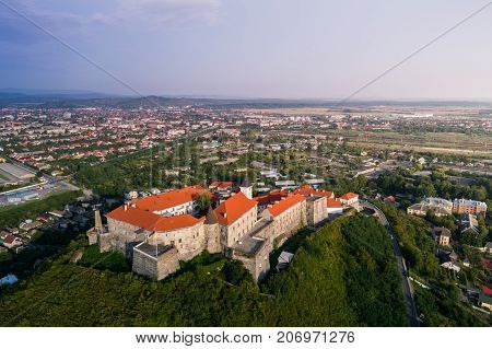 Aerial view of the Majestic Fortress - Palanok Castle towering above the city of Mukacheve, Ukraine.