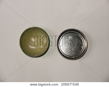 Open Small Tube Of Vaseline Top View White Background With Lid