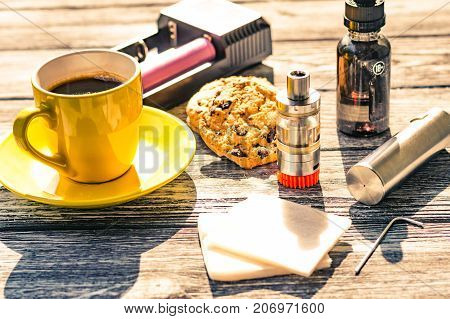 Still Life With Electronic Cigarette With Botle And Coffe On The Wooden Background