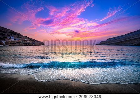 Matala beach with caves on the rocks that were used as a roman cemetery and at the decade of 70's were living hippies from all over the world, Crete, Greece