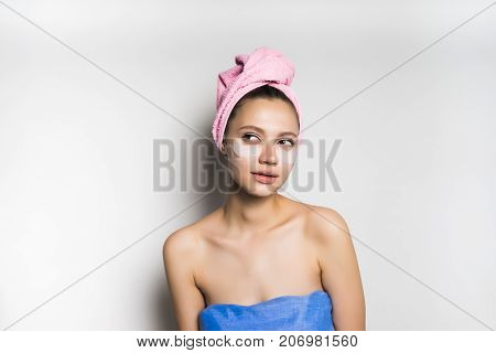 the girl after the shower looks thoughtfully aside, isolated, the bath procedures