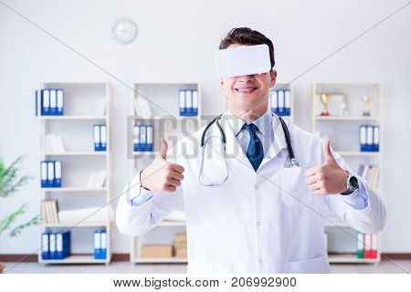 Young doctor with vr virtual reality headset working in the offi
