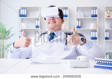 Young doctor with vr virtual reality headset working in the offi