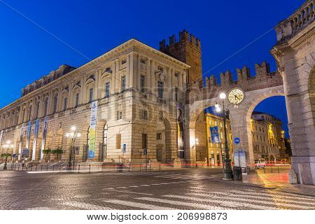 VERONA ITALY - SEPTEMBER 2017. The medieval Porta Nuova gate to the old town of Verona. Piazza Bra in Verona. Blue hour night photo with car trails