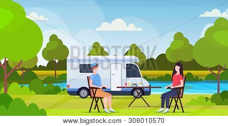Couple Sitting At Table Near Camping Family Trailer Truck Caravan Car Man Woman Spendingtime Togeher