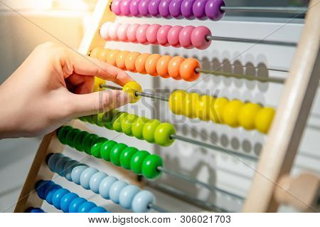 Male Hand Calculating With Beads On Wooden Rainbow Abacus For Number Calculation. Mathematics Learni