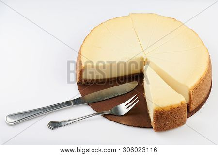 Sliced Cheesecake Pie With Fork And Knife Isolated
