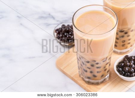 Popular Taiwan Drink - Bubble Milk Tea With Tapioca Pearl Ball In Drinking Glass On Marble White Tab