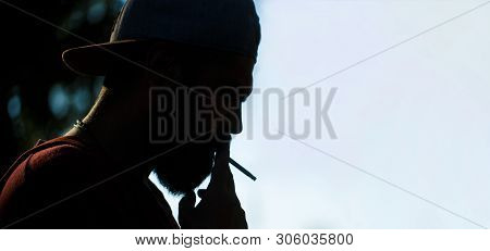Silhouette Of Bearded Man With Cigar. Beard Man And Mustache Smoke Cigar. Smoldering Cigars. Smoking