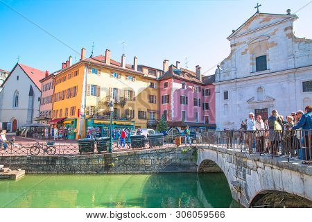 Annecy, France. 17 April 2017. Torusits Walking Across The Bridge And Old Church.