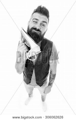 Smoothing Out. Unshaven Man Ironing Beard Hair With Clothes Iron. Hipster With Electric Ironing Tool