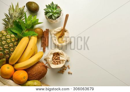 Zero Waste Food Storage. Fruits And Cereals In Eco Textile Bags, White Background. Copy Space. Flat 