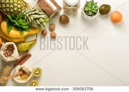 Zero Waste Concept, Frame. Fruits And Cereals In Eco Textile Bags, Glass Jars With Cereals, White Ba