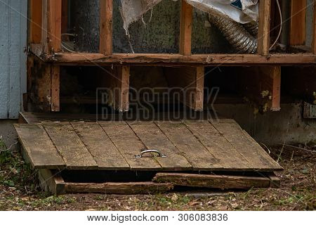 Old Wooden Hatch To Crawlspace Damaged And Splintered
