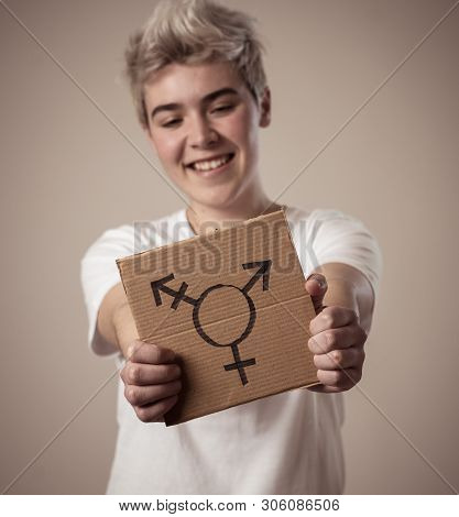 Portrait Of Happy Proud And Confident Trans Teenager Man Holding Transgender Symbol