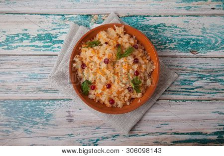 Salad Of Fermented Cabbage And Cranberries With Herbs Stands On A Wooden Blue Table On A Linen Napki