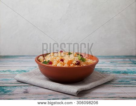 Salad Of Fermented Cabbage And Cranberries With Herbs Stands On A Wooden Blue Table On A Linen Napki