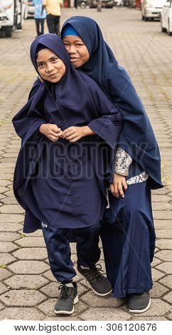 Makassar, Sulawesi, Indonesia - February 28, 2019: Closeup Portrait Of Two Young Muslima Girls, Both