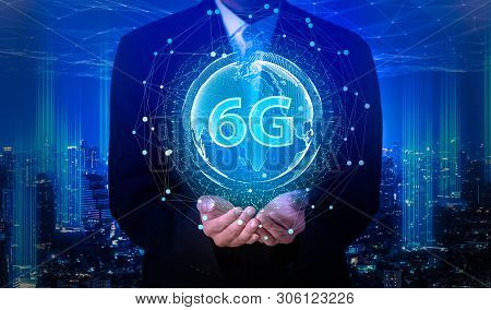 Businessman Hand Holding 6g Network Digital Hologram And Internet Of Things On City Background.6g Ne