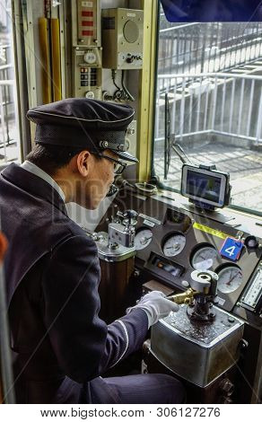 Driver Working In The Cockpit Of Train